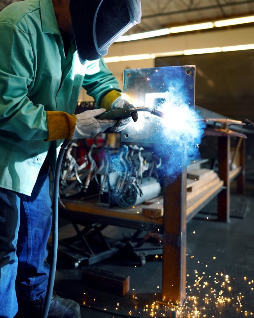 a mig welder working on a piece of metal